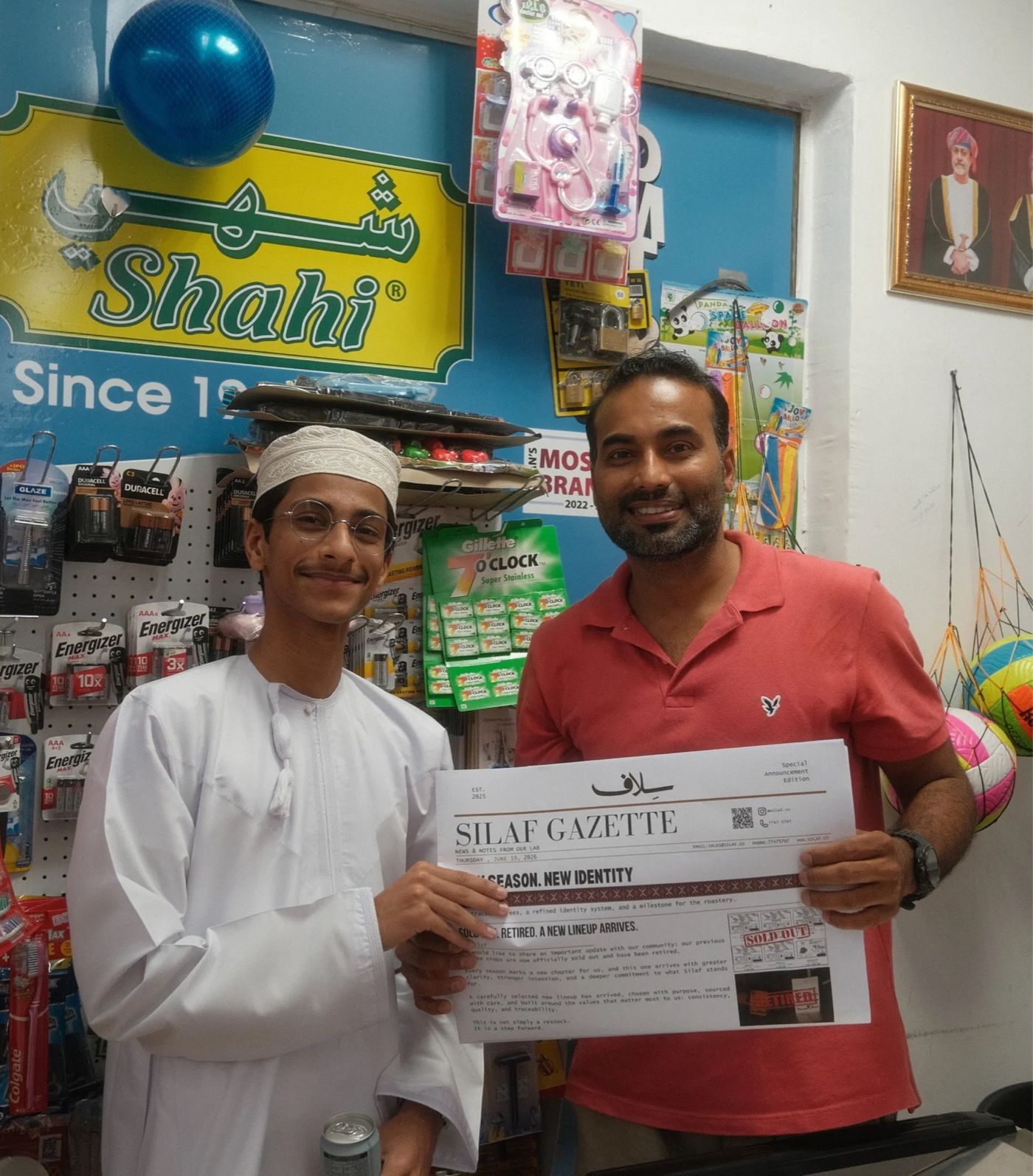 The Gazette, fresh off the press, with the shopkeeper who opened his doors for the shoot.